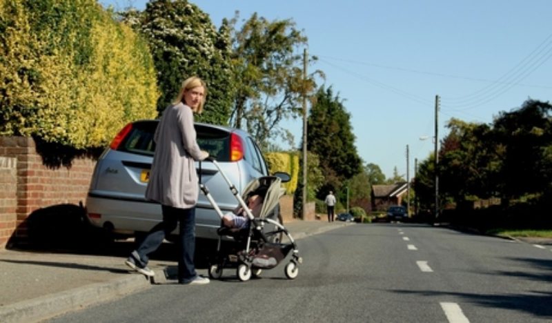 Cars parked on pavement forcing mum and pushchair on to road